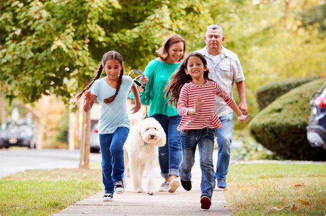 family walking in neighborhood